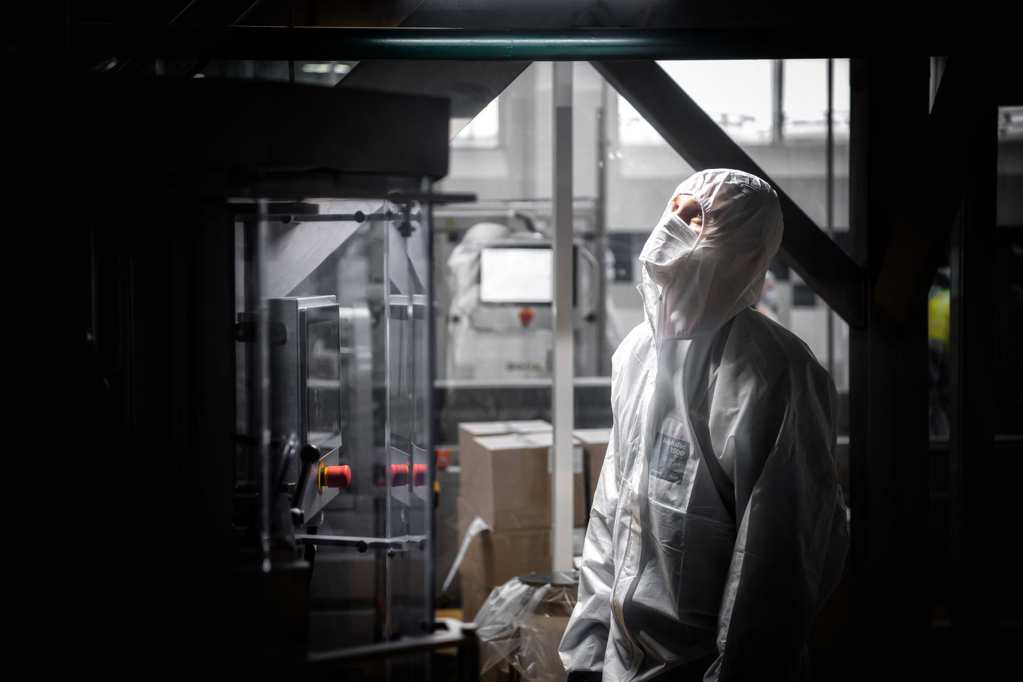 Person in a face mask in a pharmaceutical manufacturing facility