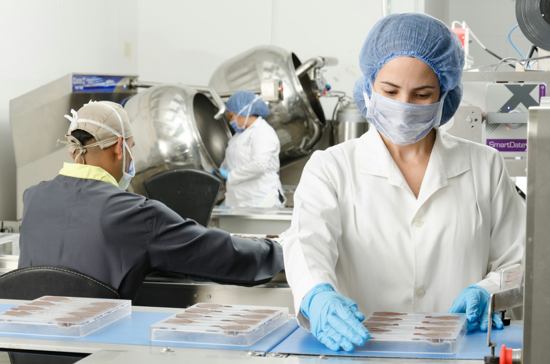 Technicians reviewing product on a production line